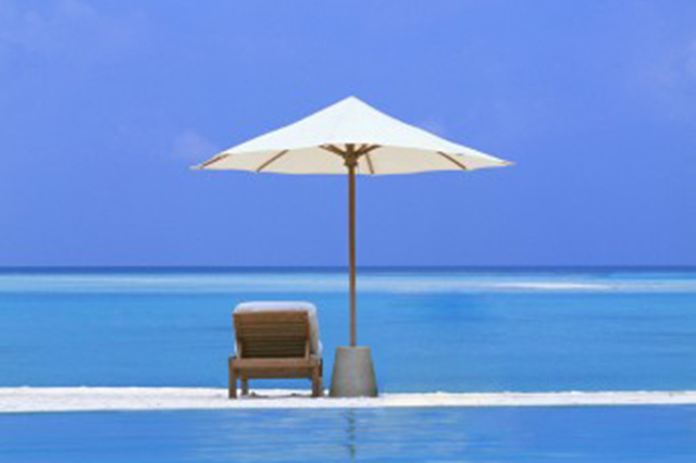 Beach image showing chair and umbrella with a sea view