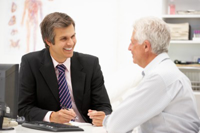 Image of doctor and a older patoient talking in a consultation