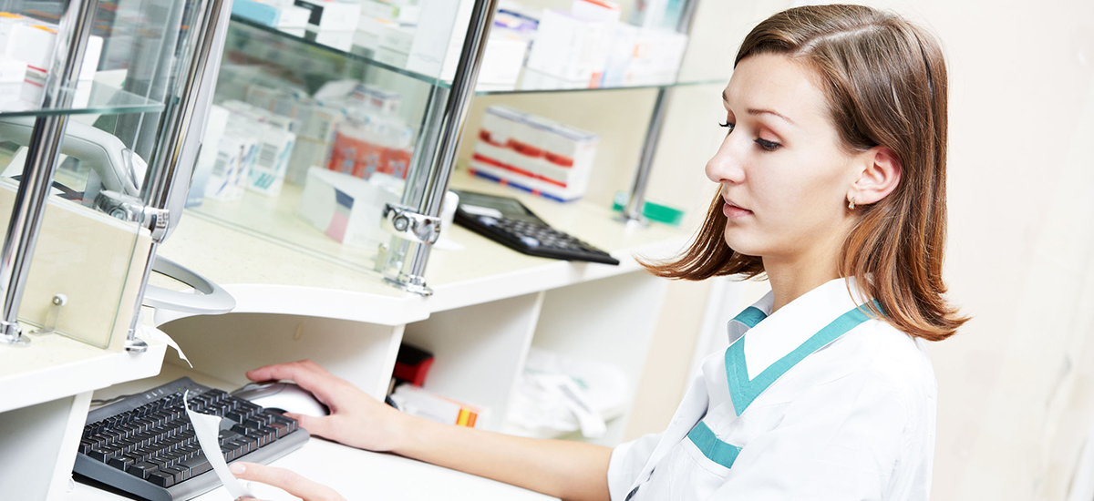 Slide Image of a pharmacist typing  into a computer
